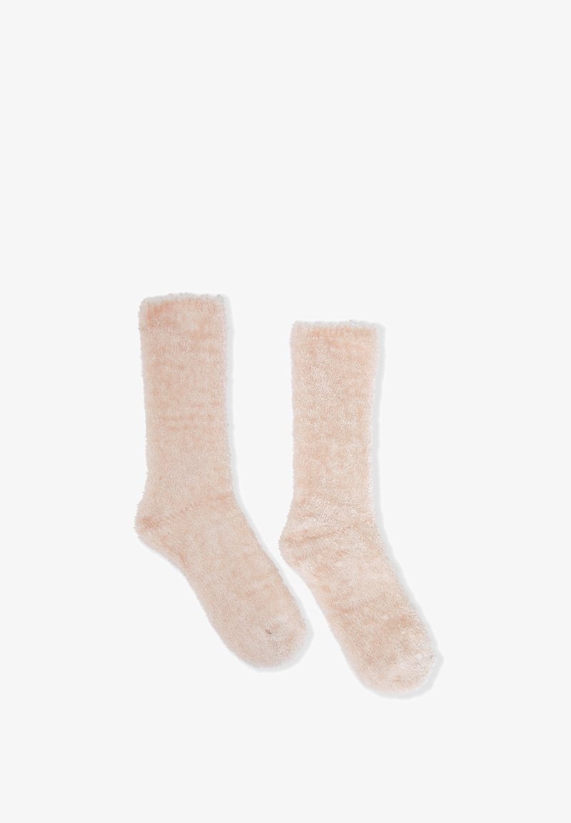 Calcetines suaves y esponjosos hasta la rodilla en color rosa claro. Con un acabado peludo y borde superior acanalado para mayor comodidad. Diseñados para mantener el calor y para uso casual.