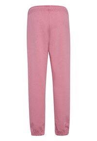 Rosa Sweatpants mit elastischem Bund und Bündchen an den Knöcheln, aus weichem Stoff, von hinten vor weißem Hintergrund gezeigt.