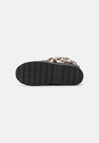 Leopard print slipper with soft fur-like upper, black rubber sole featuring horizontal traction grooves for grip and stability.