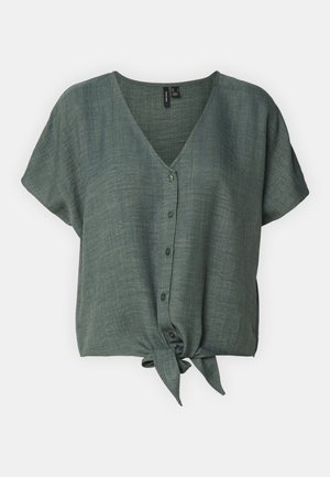 Green linen blouse with a V-neck, short sleeves, and a tie detail at the hem. Features a button closure down the front.