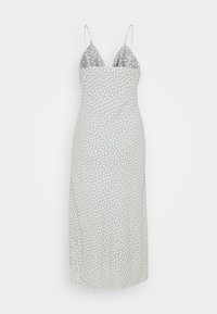 Robe midi gris clair à pois blancs, avec des bretelles spaghetti et une silhouette légèrement ajustée. Tissu doux avec une texture lisse.
