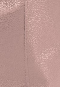 Pink leather texture with a pebbled finish, featuring visible stitching. Smooth surface with subtle sheen and no prominent patterns.
