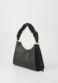 Black leather handbag with a braided handle, smooth texture, zip closure, and gold accents. Features a structured, slouchy design.
