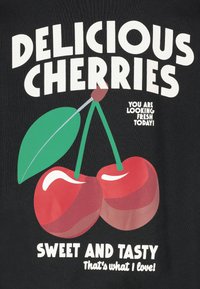 Black background with bold text. Design features two red cherries with a green leaf. Text includes "Delicious Cherries" and "Sweet and Tasty."