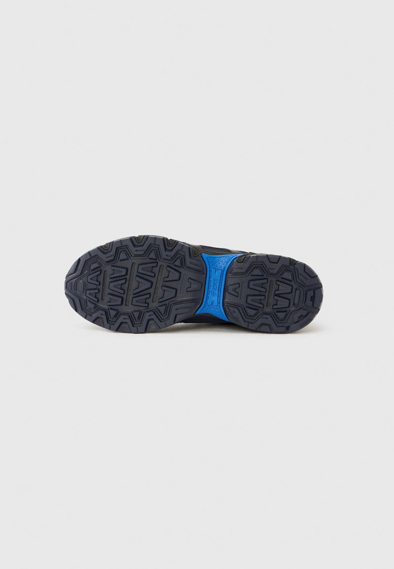 Black athletic shoe outsole featuring a textured rubber surface, blue midsole accent, and pronounced tread pattern for enhanced grip.