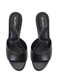 Chanclas negras con un acabado de cuero suave, con una correa frontal ancha y una plantilla contorneada; logo de la marca en dorado en la plantilla.