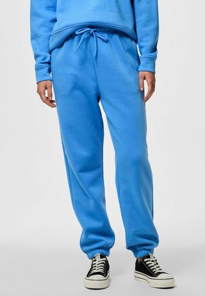 Pantaloni jogger blu cielo realizzati in tessuto morbido, con vita e polsini elasticizzati, dotati di tasche laterali e dettagli con cordoncino.