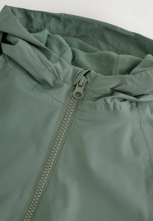 Light green jacket with a fleece-lined hood, featuring a central zipper, smooth fabric exterior, and contrasting textured fleece interior.