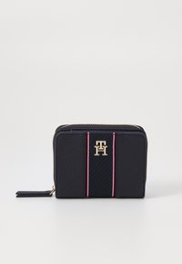Navy leather wallet with textured finish, gold hardware, and striped accents in red and white. Features a zip closure and logo detail.
