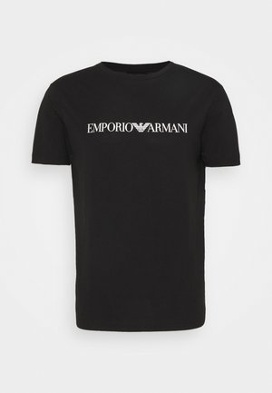Black cotton t-shirt featuring a white printed logo reading "EMPORIO ARMANI" across the chest, short sleeves, and a crew neck design.