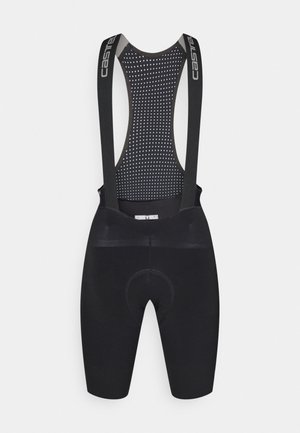 Culotes de ciclismo pretos com costas em malha, apresentando alças ajustáveis, assento acolchoado e um design texturizado para respirabilidade.