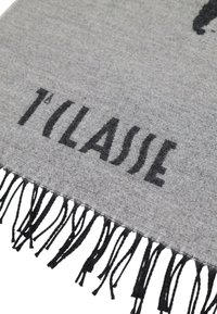 Sciarpa in tessuto grigio con bordo frangiato e testo stampato in nero che recita "1° CLASSE." Il tessuto ha un aspetto morbido e testurizzato.