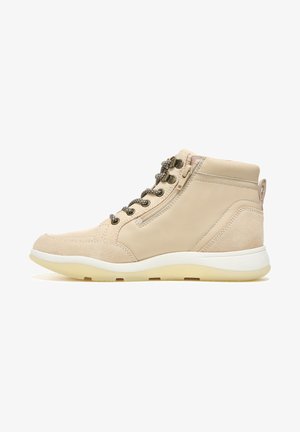 Beige high-top shoes made of leather and suede, featuring a textured surface, padded collar, metallic laces, and a white rubber sole.