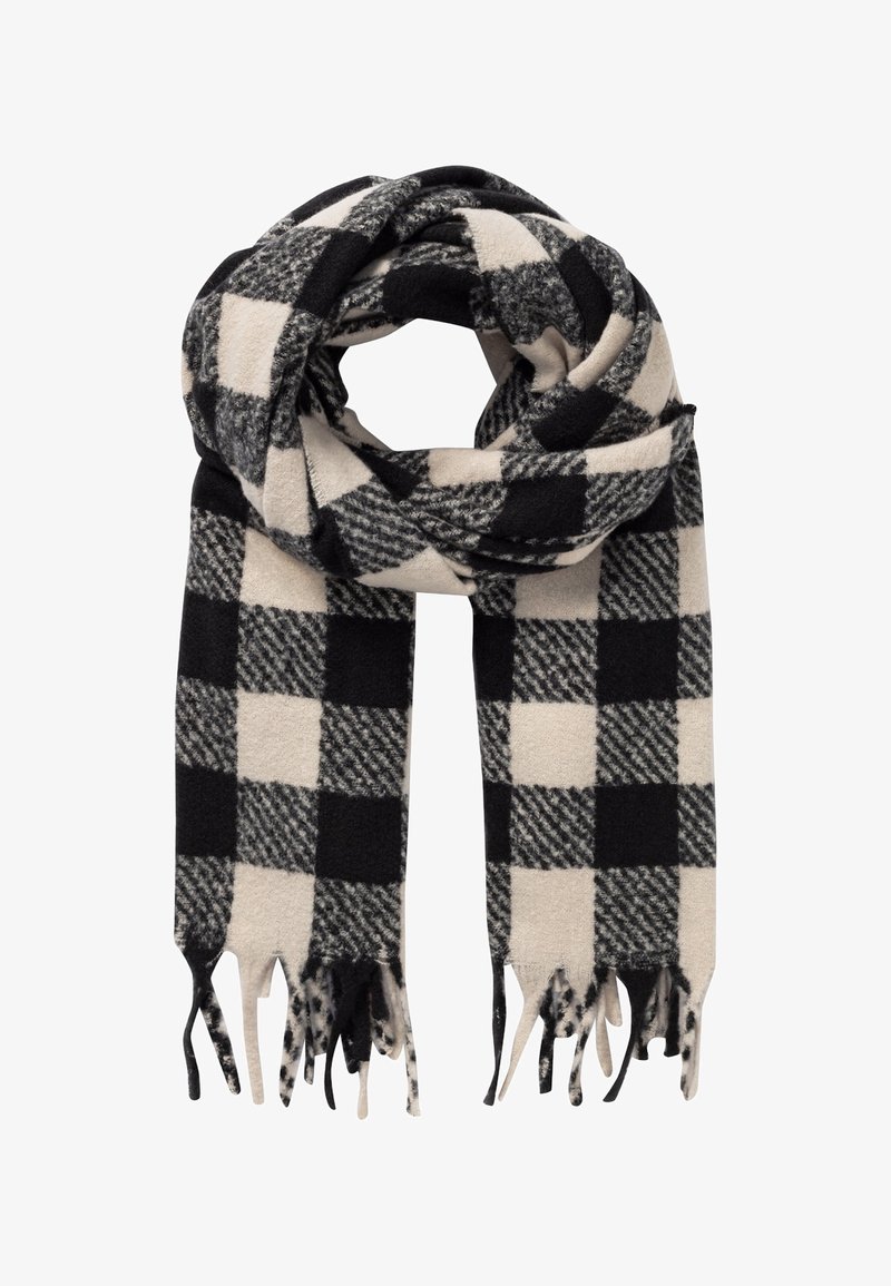 Écharpe en laine à carreaux noirs et blancs avec extrémités à franges, pliée en boucle sur un fond blanc.