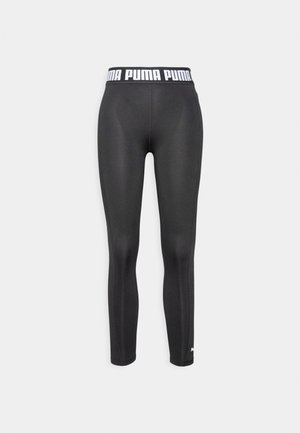 Leggings sportivi neri con design aderente, vita elastica con il logo "PUMA" in bianco e una texture di tessuto liscia e elastica.