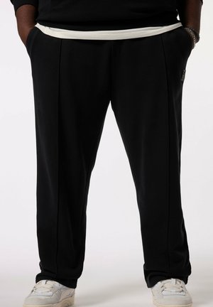 Zwarte sweatpants met een witte elastische tailleband, voorzien van zijzakken, een rechte snit en subtiele naaddetails.