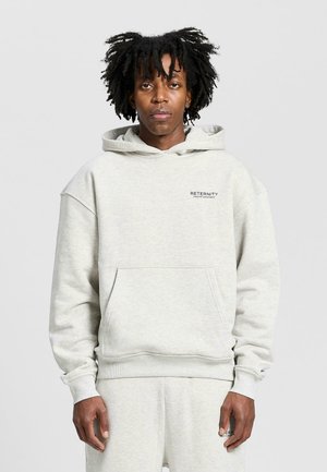 Light gray hooded sweatshirt in fleece material, featuring a front pocket, ribbed cuffs, and "RETERNITY" logo printed on the chest.