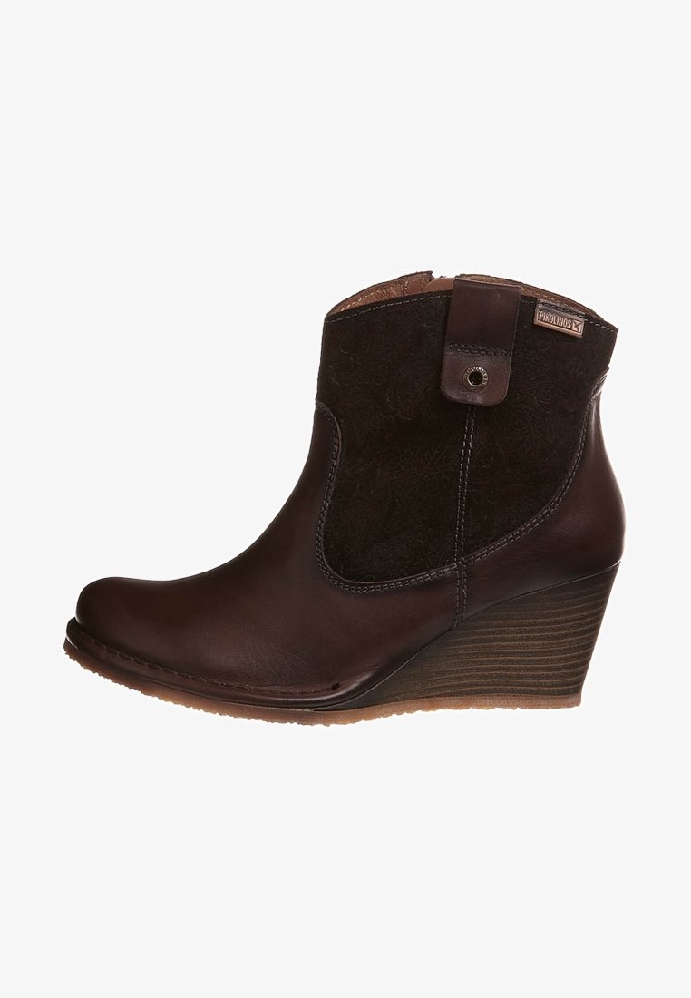 Brown leather ankle boots with a wedge heel, featuring a textured dark fabric panel and a side snap detail.