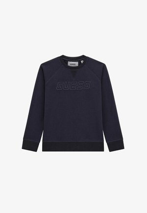 Námořnická mikina se střihem crew neck, raglánovými rukávy a texturovaným logem "GUESS" v kontrastní tmavě námořnické barvě. Směs bavlny, měkký povrch, pružné manžety.