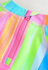 Colorful swimwear with pink, green, and blue vertical stripes. Features a pink zipper closure and soft, lightweight material.