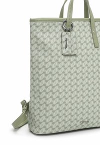 Sac fourre-tout vert clair avec motif géométrique. Fabriqué en matériau texturé, il dispose de poignées supérieures, d'une bandoulière amovible et d'une étiquette de marque.