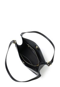 Black leather tote bag with a wide opening, single shoulder strap, gold hardware accents, and interior compartments including a zip pocket.