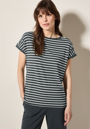 T-shirt rayé vert foncé en tissu doux avec une coupe décontractée, présentant des rayures horizontales blanches et un col large. Manches courtes roulées.