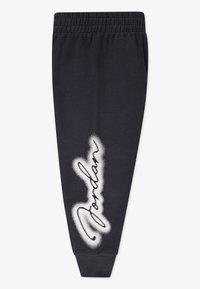 Pantalons de jogging bleu foncé en coton. Dotés d'une taille élastique et d'un graphique "Jordan" en spray blanc sur la jambe gauche.