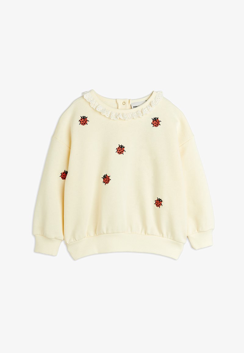 Felpa crema con un colletto testurizzato, featuring delle coccinelle rosse ricamate e accenti neri sparsi su tutta la superficie.