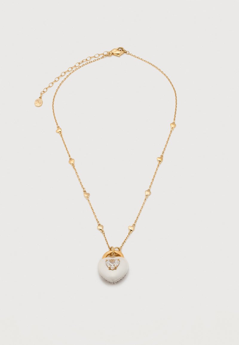 Χρυσό κολιέ αλυσίδα με μικρούς κρίκους σε σχήμα καρδιάς και λευκό μενταγιόν σε σχήμα καρδιάς με κεντρική καθαρή πολύτιμη πέτρα και χρυσές λεπτομέρειες.