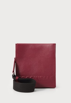 Burgundy leather crossbody bag with a textured finish, rectangular shape, and a black fabric strap. Features embossed logo detail.