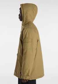 Yellow hooded jacket with a zippered front, elastic cuffs, and a single patch pocket on the left sleeve. Fleece-lined hood for warmth.