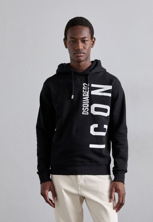 Sudadera con capucha negra de algodón, que presenta un atrevido texto blanco "DSQUARED?" y "ICON" impreso verticalmente. Incluye capucha con cordón.