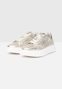 Metallisch silberne Sneakers mit glattem Obermaterial und strukturierten Seitenpaneelen, weißer Gummisohle, Schnürsenkeln und minimalen Akzenten.