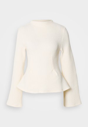 Cream ribbed knit top with a high neckline, long flared sleeves, and a peplum hem. Textured fabric adds visual interest.