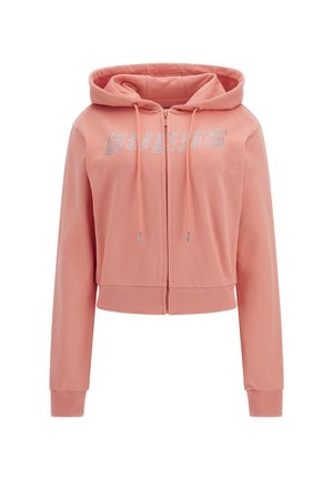 Pink zip-up hoodie made of soft fabric, featuring a ribbed hem and cuffs. "GUESS" logo in rhinestones across the chest, with adjustable drawstrings.