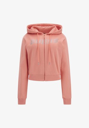 Felpa rosa con zip realizzata in tessuto morbido, caratterizzata da un orlo e polsini a costine. Logo "GUESS" in strass sul petto, con cordini regolabili.