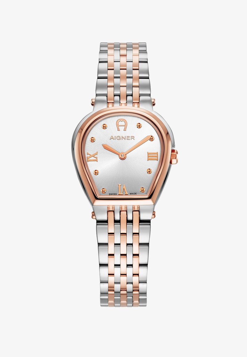 Sidabrinė ir rožinio aukso laikrodžiai su ašaros formos korpusu, romėniškais skaitmenimis ir sujungta metaline apyranke. Apima tekstūruotą sidabro ciferblatą.