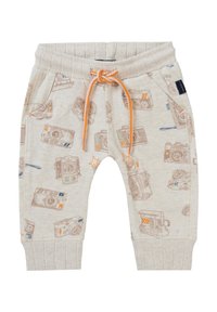 Licht beige joggingbroek met camerapatronen, elastische tailleband, verstelbare oranje trekkoord en omgerolde enkels.