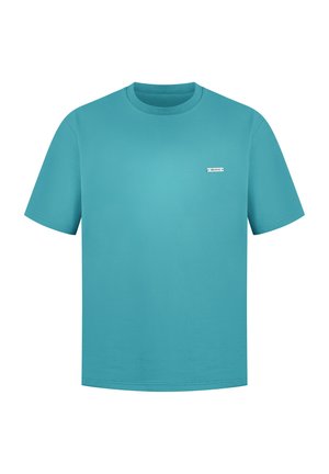 Turquoise cotton t-shirt with short sleeves, crew neck, and a small white logo patch on the left chest. Smooth texture, straight cut.