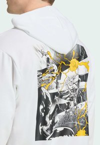 White hoodie featuring a graphic print on the back with black and yellow comic-style illustrations of characters and lightning motifs.