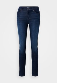 Donkerblauwe jeans van denim, met een slim fit, vijf-pocket ontwerp, riemlussen en een ritssluiting met knoopsluiting.