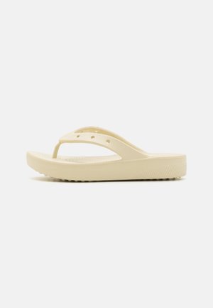 Yellow plastic flip-flop with a thick sole, V-shaped strap, and vent holes on the upper part for breathability. Textured bottom for grip.