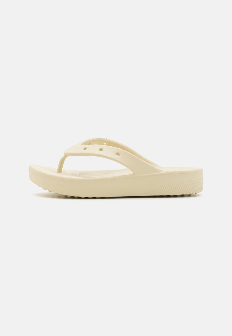Yellow plastic flip-flop with a thick sole, V-shaped strap, and vent holes on the upper part for breathability. Textured bottom for grip.