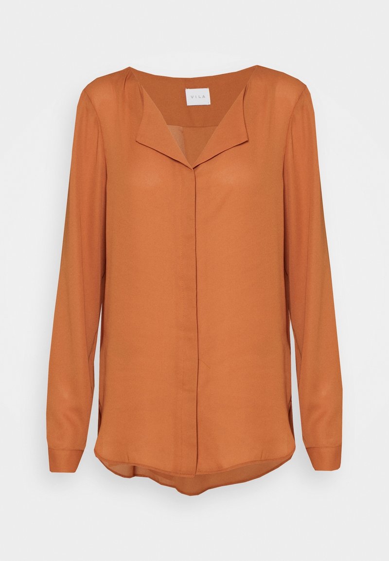 Blusa a maniche lunghe color ruggine con scollo a V, tessuto morbido, chiusura con bottoni e spacchi laterali per una maggiore libertà di movimento.