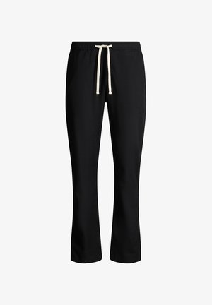 Schwarze gerade geschnittene Hose mit elastischem Bund und weißem Kordelzug, vor weißem Hintergrund dargestellt.