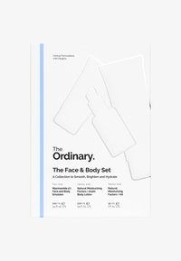 Białe opakowanie z niebieskim akcentem. Zawiera trzy zarysy produktów: butelka i dwa kształty tubek. Tekst zawiera nazwy produktów i ich rozmiary.