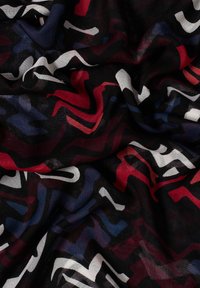 Multicolored abstract scarf featuring wavy patterns in red, blue, and white on a black background. Lightweight fabric with a smooth texture.