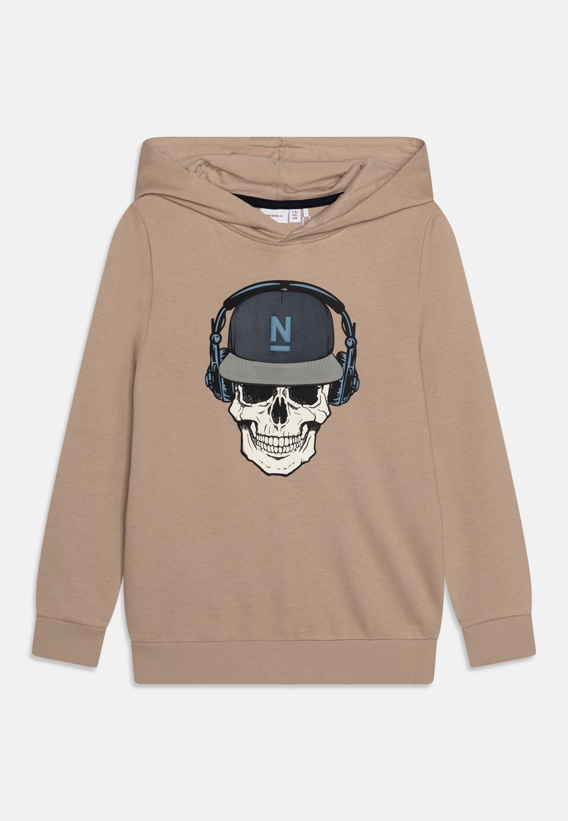 Sweat à capuche beige avec un grand graphique d'un crâne portant un casque audio et une casquette avec un logo "N" bleu. Fabriqué en coton doux.