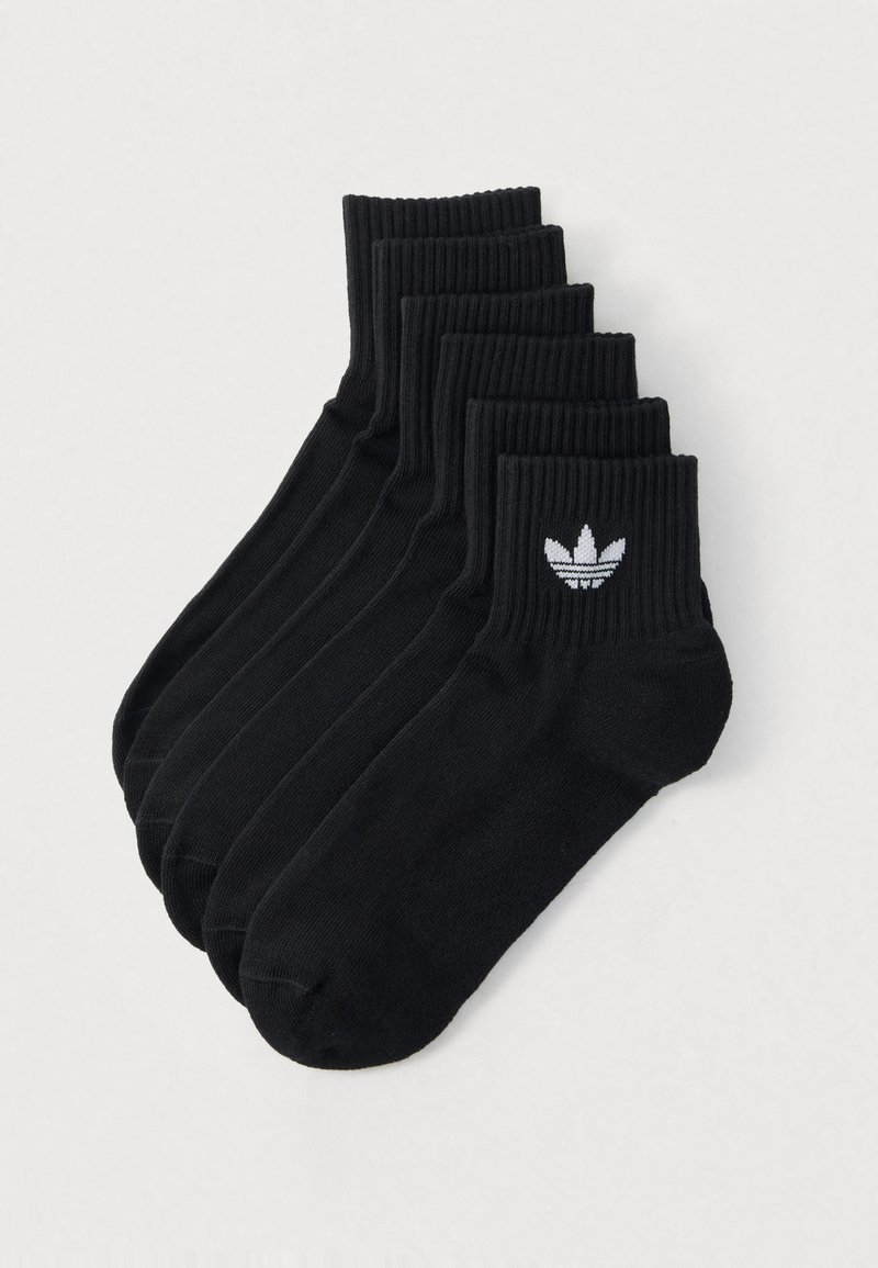 Black ankle socks, ribbed design, featuring a white embroidered logo. Pack of five pairs, made from soft, stretchable fabric.